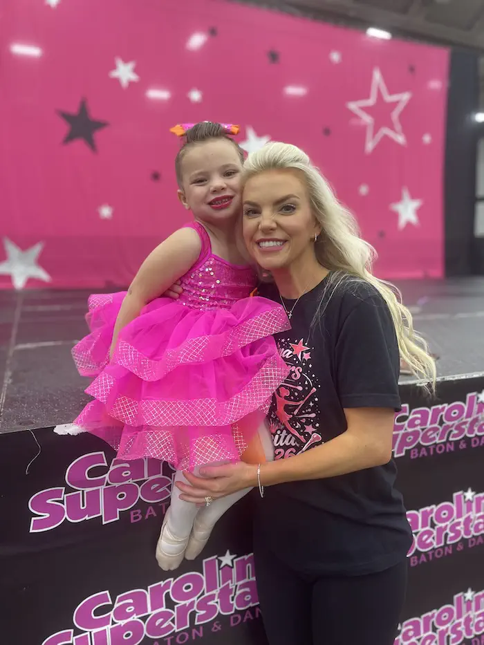 Ansley and young girl in pink dance costume at competition